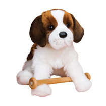 A st. bernard plush sitting with a toy.